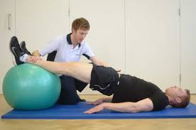 Strengthening exercises for hip muscles with swiss ball