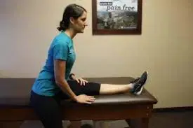 Hamstring stretch at the edge of a bed