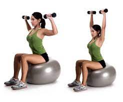 Dumbbell shoulder press on exercise ball